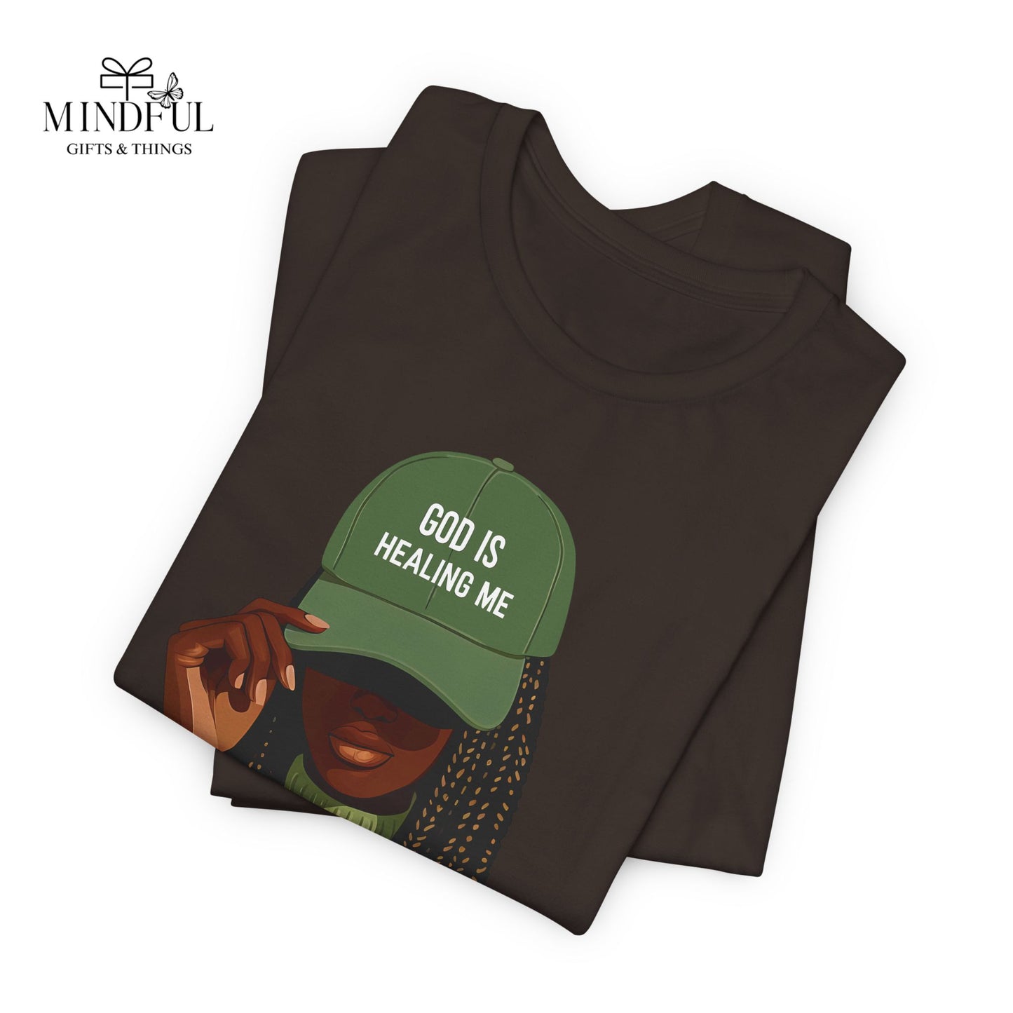 God Is Healing Me Tee — Inspirational Faith T‑Shirt with Green Cap Graphic