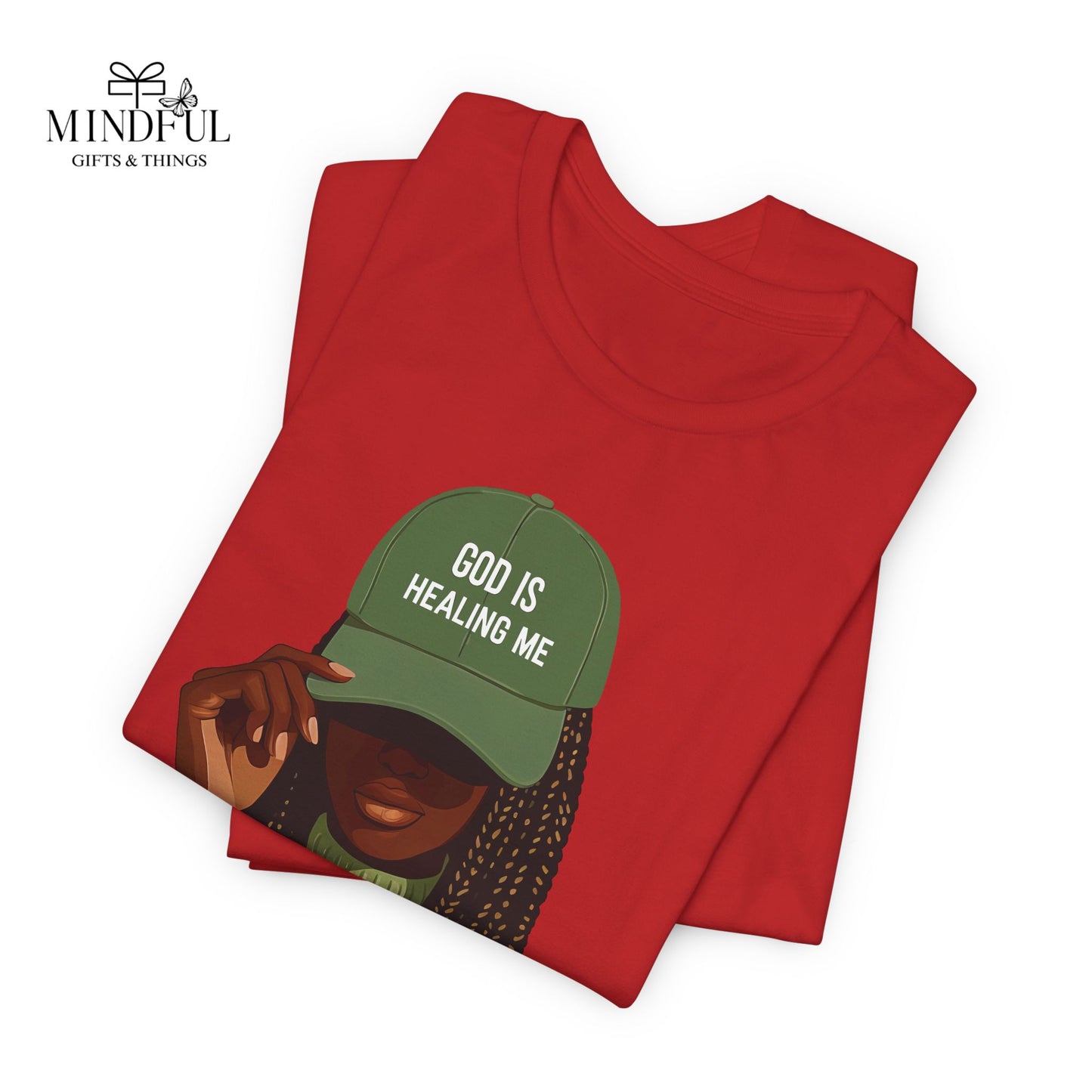 God Is Healing Me Tee — Inspirational Faith T‑Shirt with Green Cap Graphic