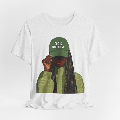 God Is Healing Me Tee — Inspirational Faith T‑Shirt with Green Cap Graphic