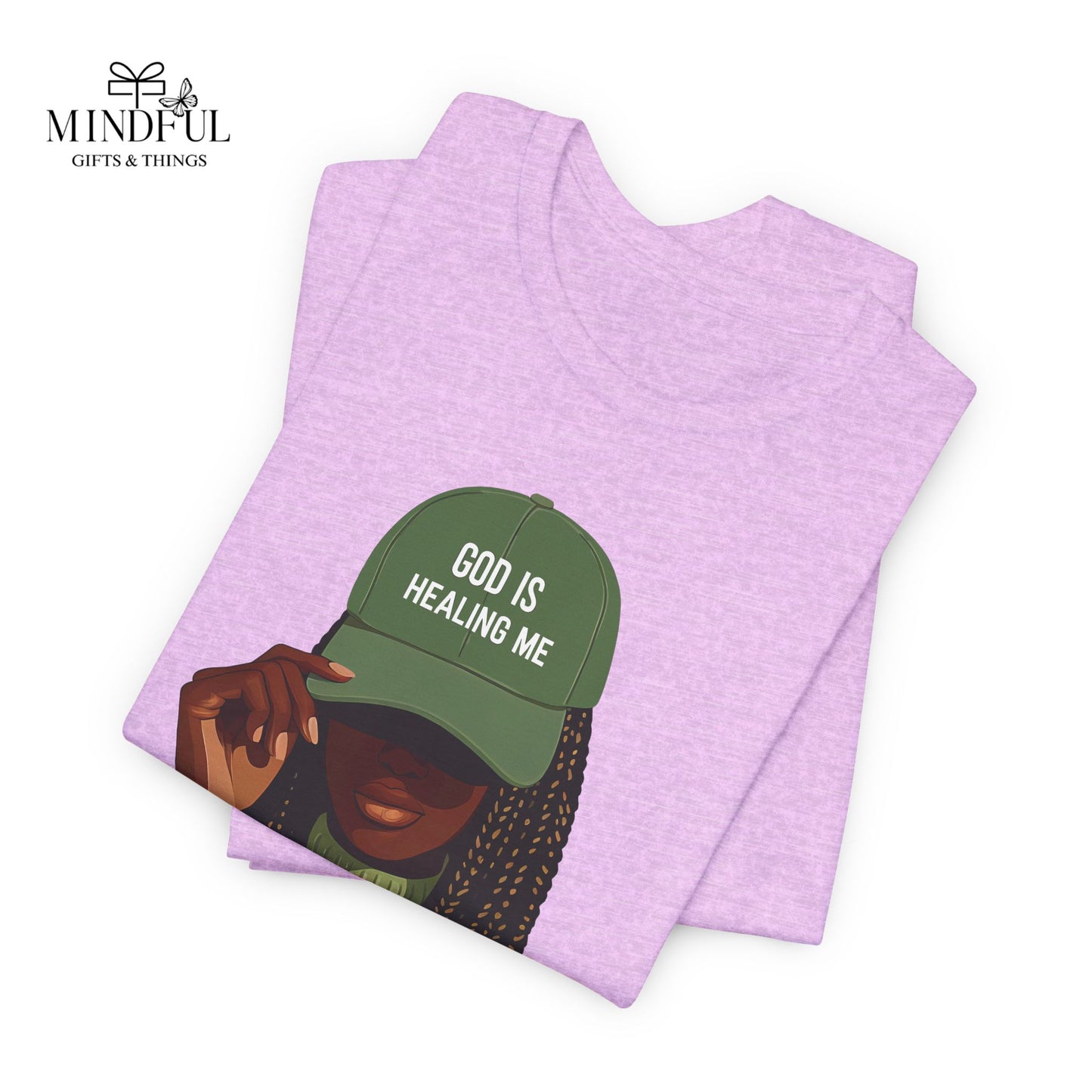 God Is Healing Me Tee — Inspirational Faith T‑Shirt with Green Cap Graphic
