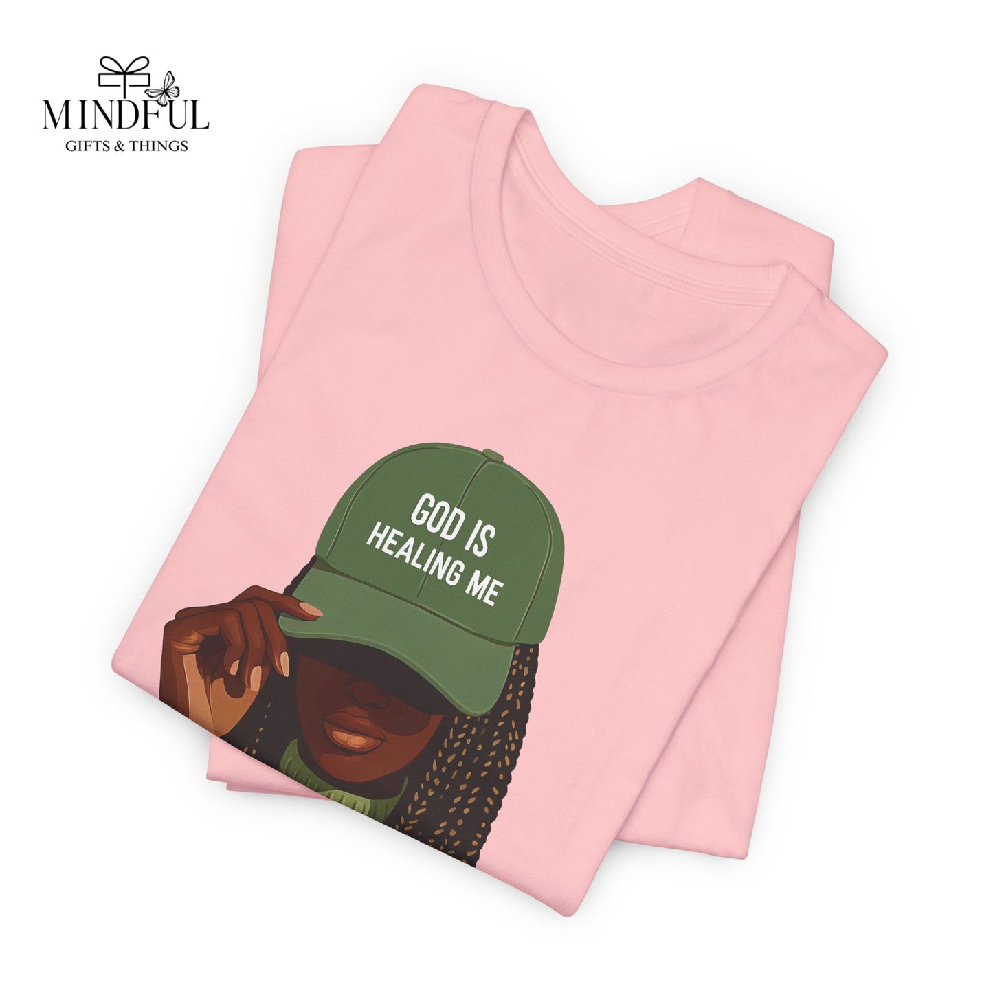 God Is Healing Me Tee — Inspirational Faith T‑Shirt with Green Cap Graphic