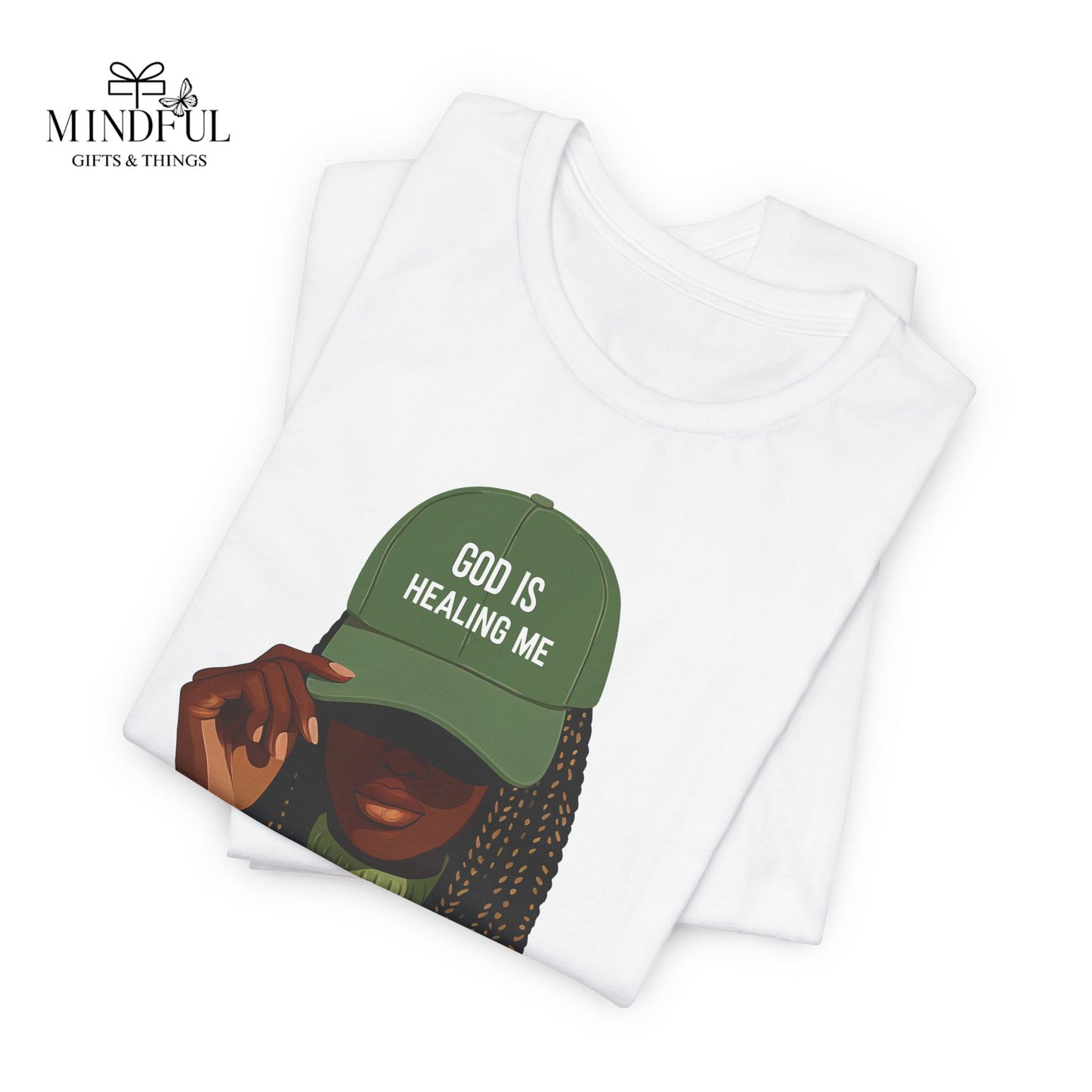 God Is Healing Me Tee — Inspirational Faith T‑Shirt with Green Cap Graphic