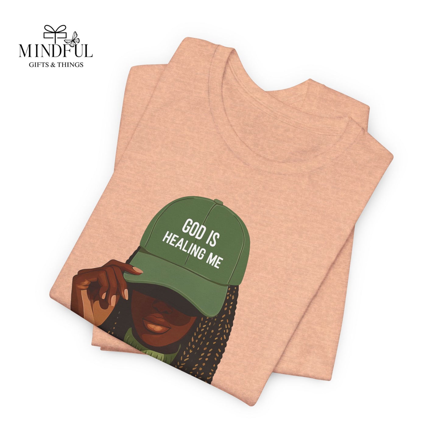 God Is Healing Me Tee — Inspirational Faith T‑Shirt with Green Cap Graphic