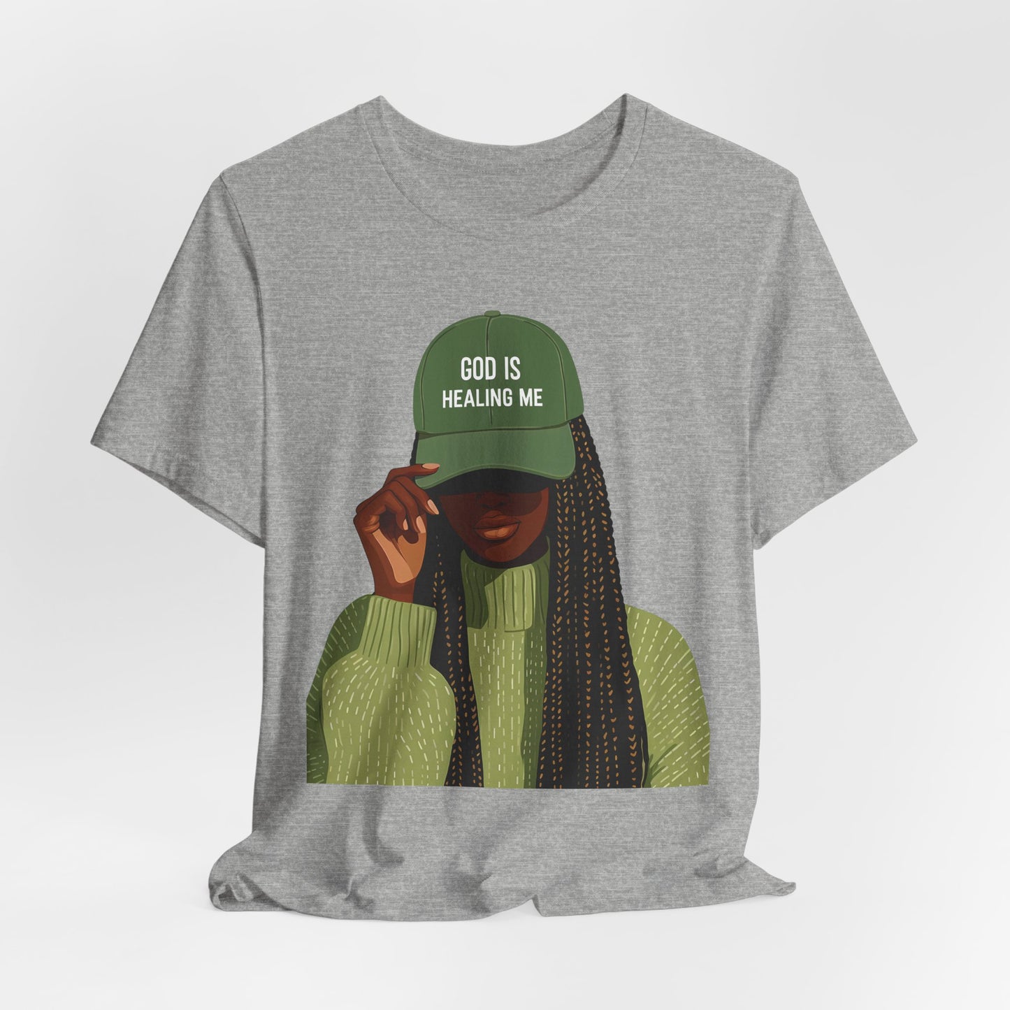 God Is Healing Me Tee — Inspirational Faith T‑Shirt with Green Cap Graphic