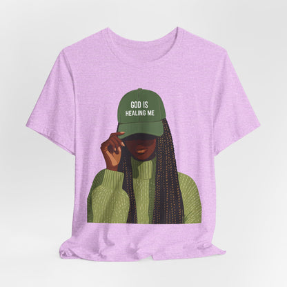 God Is Healing Me Tee — Inspirational Faith T‑Shirt with Green Cap Graphic