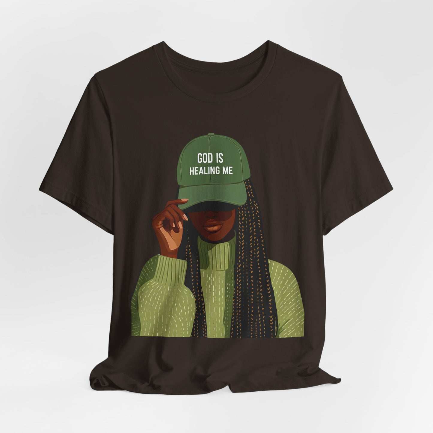 God Is Healing Me Tee — Inspirational Faith T‑Shirt with Green Cap Graphic