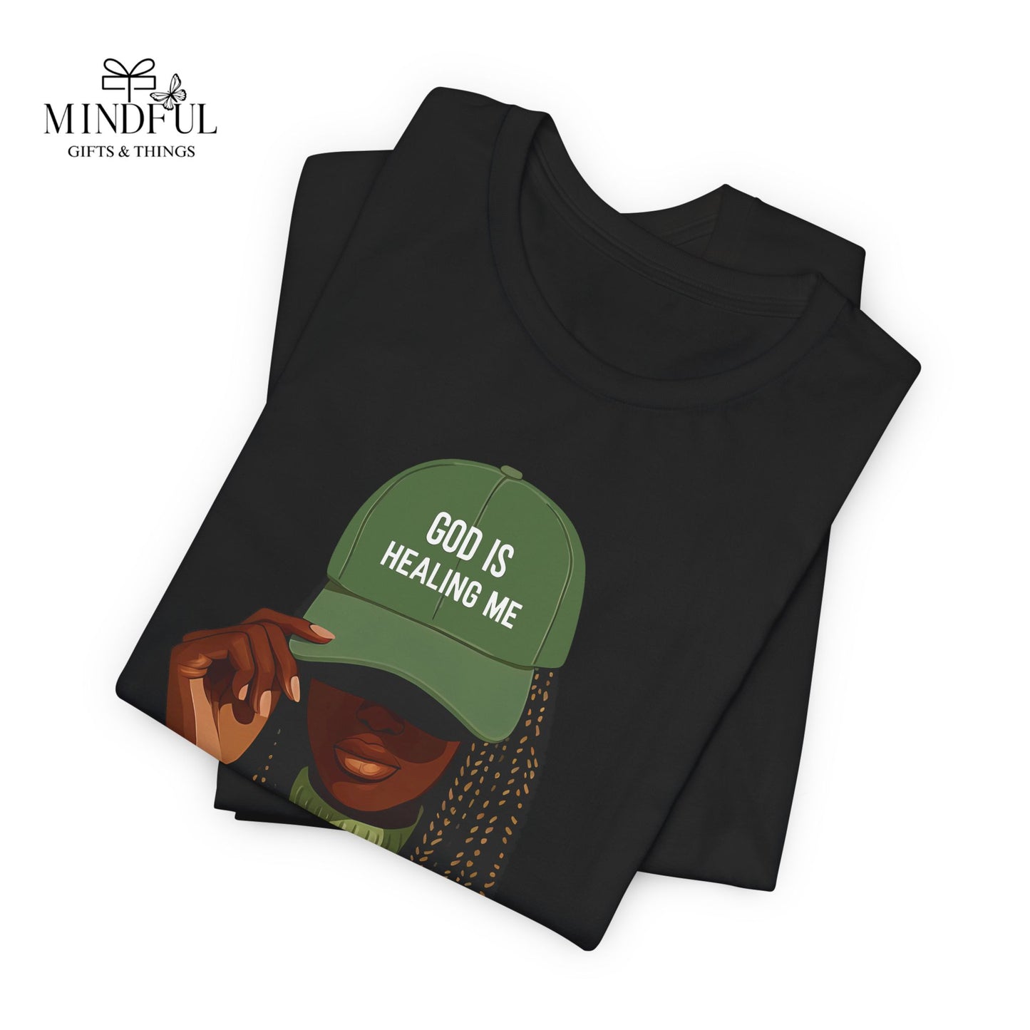 God Is Healing Me Tee — Inspirational Faith T‑Shirt with Green Cap Graphic