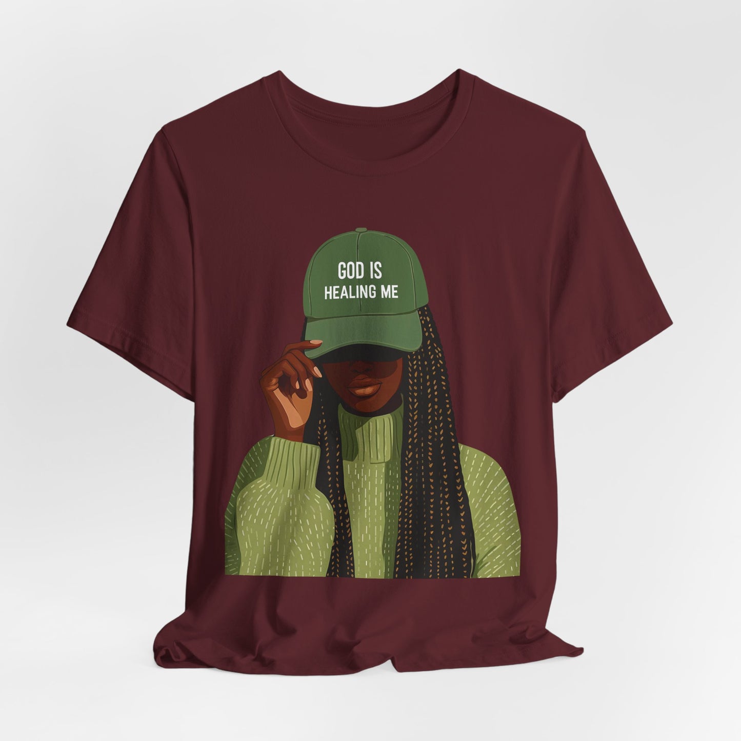 God Is Healing Me Tee — Inspirational Faith T‑Shirt with Green Cap Graphic