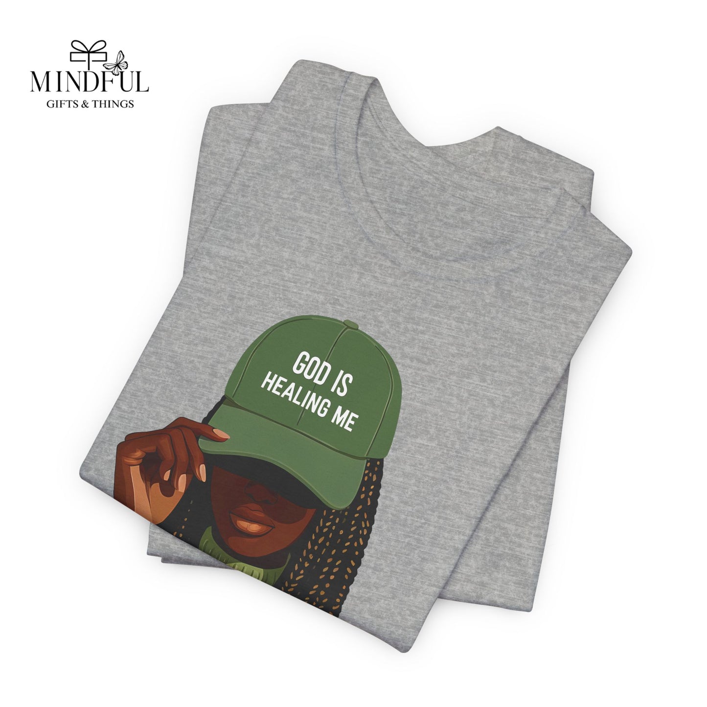 God Is Healing Me Tee — Inspirational Faith T‑Shirt with Green Cap Graphic