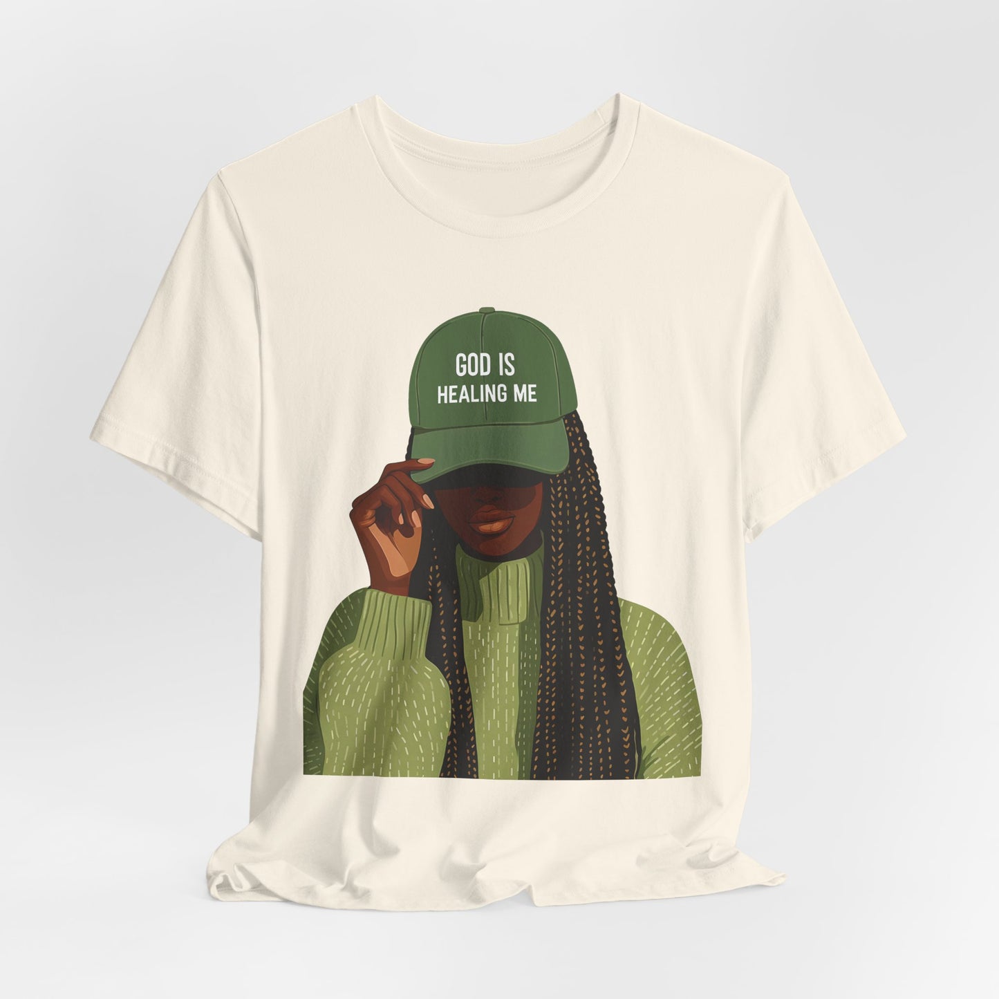 God Is Healing Me Tee — Inspirational Faith T‑Shirt with Green Cap Graphic