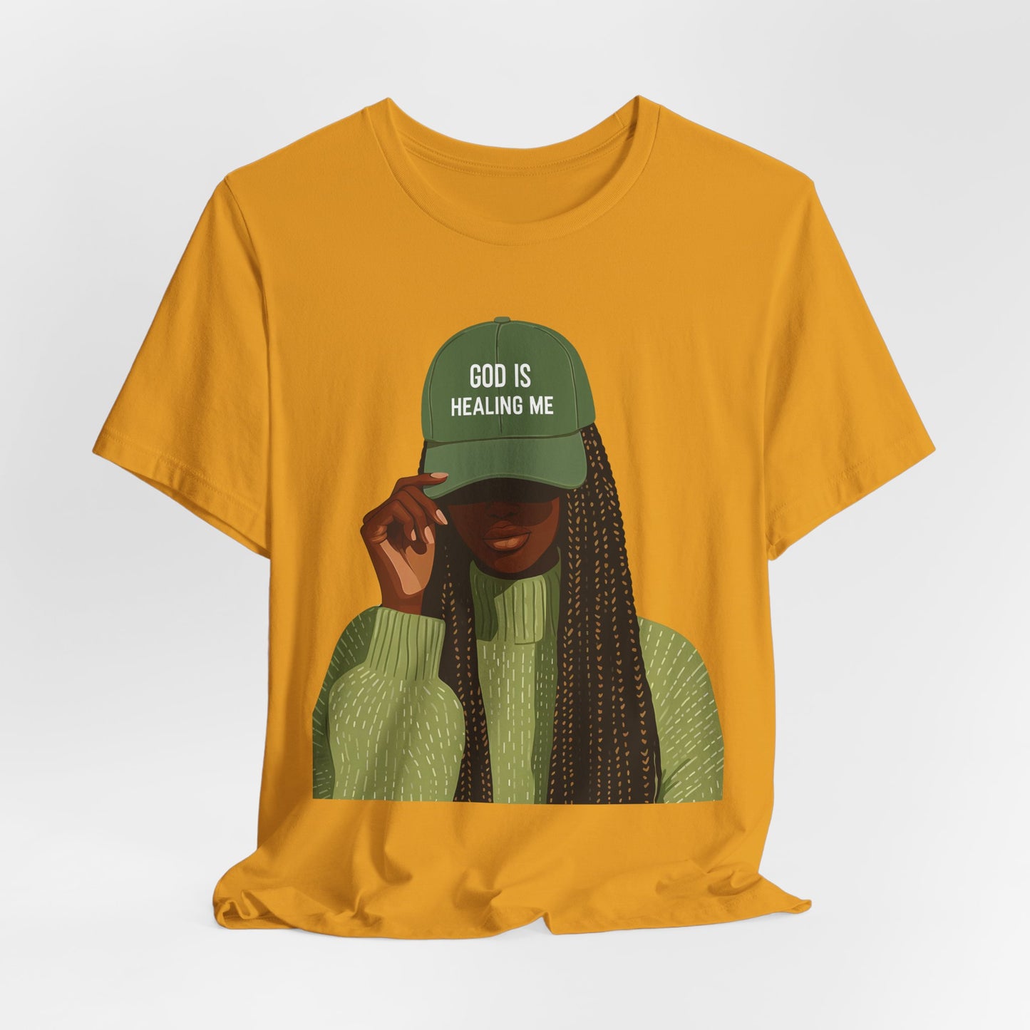 God Is Healing Me Tee — Inspirational Faith T‑Shirt with Green Cap Graphic